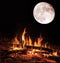 Camp fire and big moon at night