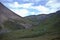 A camp of hunters and horses grazing in mountains