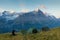 Camp in mountains. Dreamy mountains, orange sunrise in a beautiful valley. Colorful summer view of the Eiger, Alps on background.