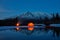 Camp near the mountain lake. Night landscape with a tent near the water.