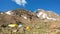 The camp place and camping tents backed by rocks in Mount Sabalan , Iran