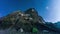 Camp tents under beautiful moving sky in mountains.