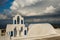 Campanile of the white church and scenic cloud, Oia, Santorini,