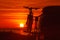 Camper with bicycles on rack camping on beach at sunrise