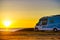 Camper car on beach at sunrise