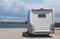 camper car on the sandy shore near the river on a summer day