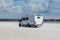 Camper car on the sandy shore near the river on a summer day