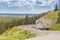 Camper Driving Down Road in The Beautiful Countryside Among Pine