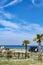 Camper, mobile home or caravan vacation, free parking of beach with palm trees and blue sea