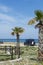 Camper, mobile home or caravan vacation, free parking of beach with palm trees and blue sea