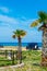 Camper, mobile home or caravan vacation, free parking of beach with palm trees and blue sea