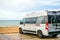 Camper parked close to beach with bikes equipped