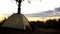 Camper resting in tent early in picturesque place, overnight in wild, sunrise