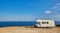 Camper rv caravan on mediterranean coast in Italy. Wild camping on sea shore
