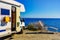 Camper rv on sea with clothes to dry