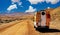 Camper truck trip on red dirt track sand road, barren lonely wild desert valley - Chile, Atacama region, Pan de Azucar NP