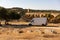 Camper van in Alentejo landscape with abandoned destroyed Ajuda bridge behind, in Portugal