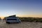 Camper van parked at an idyllic beach access at sunrise