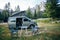 Camper van on rest stop under mountain