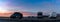 Camper vans parked in a beachfront parking lot under an amazing sunset sky in southern Spain