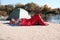 Campers lying in sleeping bags on beach
