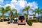 Campervan on campsite with palm trees and backdoors doors open