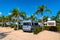 Campervan on tropical campsite with palm trees in summer sun