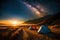 A campfire burning bright under a starry night sky, with tents pitched nearby for a cozy camping experience