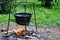 Campfire cooking in cauldron