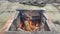 Campfire flaming in rustic fireplace outdoor