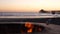 Campfire pit in California USA. Camp fire on ocean sea beach, roasting toast marshmallow on bonfire.