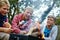 Campfire stories and snacks. three young boys cooking marshmallows over the campfire.