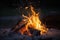 Campfire at touristic camp in the night. Flame and fire sparks on dark background. Generative AI