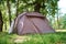 Campimg tent in pine forest in a summer day. Tourist camp