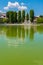 Campina, Romania - August 16, 2018: view of the cursed Bride`s Lake or the Church Lake showing green trees and water fountain sit