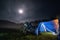 Camping, blue tent with light, touring motorcycle for travel. The concept of recreation and tourism. Space for text, selective