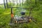 Camping bonfire with cauldron and firewood with ax in forest. Traveling hiking background