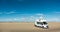 Camping Car RV standing on empty sand beach panorama on sunny day. Romo Bilstrand, Lakolk Strand, Denmark.