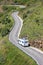 Camping caravan car camper on road Europe european Spain France holiday aerial view trip curvy trailer camp driving travel drive