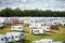 Camping, caravan and outdoor music festival in park for celebration on fun holiday vacation in summer. Travel, people or