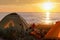 Camping cyclists on the sea, tourist tent on the beach