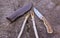 Camping damascus blade knife, sheath and sticks on wood log