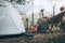 Camping equipment, bags, shoes, ukulele, tripod beside the tent in the morning. Object camp, Travel and vacation concept