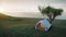 Camping.Evening scence.Tent under the big tree on a meadow,hill,mountains with sea background.