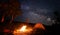 Camping fire and tent under the amazing starry sky with lot of shining stars