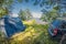 Camping in forest by the lake. Tent near the car. distortion perspective fisheye lens