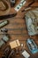 Camping gear including knife, clothes, boots, lantern, camera, hat, map, compass. Vertical wanderlust, safari postcard, poster,