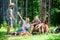 Camping and hiking. Company friends relaxing and having snack picnic nature background. Relax in nature environment