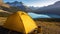 Camping with holding cup in yellow tent open with Peyto Lake in Icefields Parkway at Canada