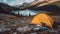 Camping with holding cup in yellow tent open with Peyto Lake in Icefields Parkway at Canada